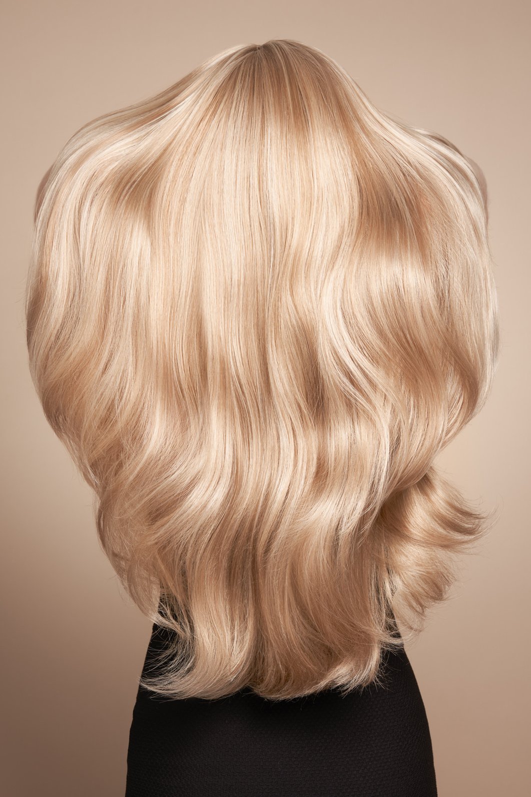 Back view of woman with long beautiful blond hair